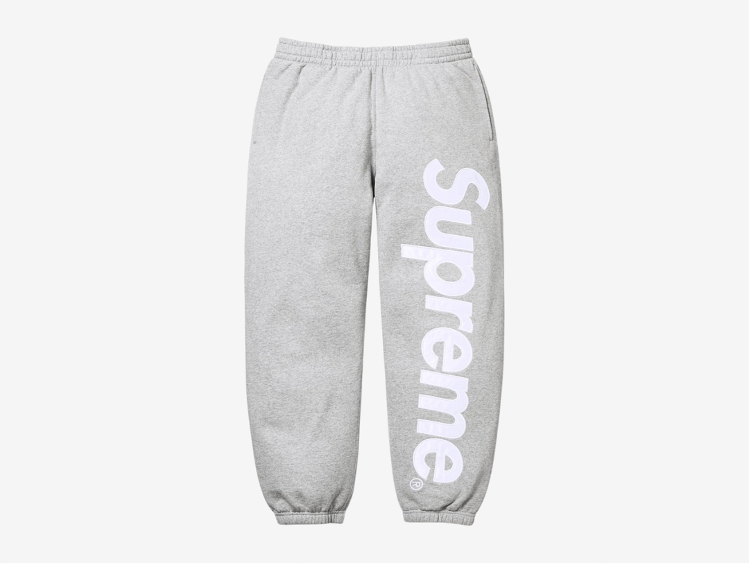 The Supreme Appliqué Logo Sweatpants in Grey bring a clean, versatile look with the same soft, heavyweight fleece for steady comfort. The appliqué Supreme logo along the leg adds texture and a clear point of focus, while the elastic waistband and drawcord secure the fit. The relaxed silhouette keeps them easy to wear, and the neutral grey colorway makes styling simple. These sweatpants fit well for anyone who wants dependable comfort with a sharp Supreme detail.