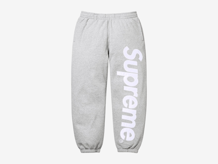 The Supreme Appliqué Logo Sweatpants in Grey bring a clean, versatile look with the same soft, heavyweight fleece for steady comfort. The appliqué Supreme logo along the leg adds texture and a clear point of focus, while the elastic waistband and drawcord secure the fit. The relaxed silhouette keeps them easy to wear, and the neutral grey colorway makes styling simple. These sweatpants fit well for anyone who wants dependable comfort with a sharp Supreme detail.