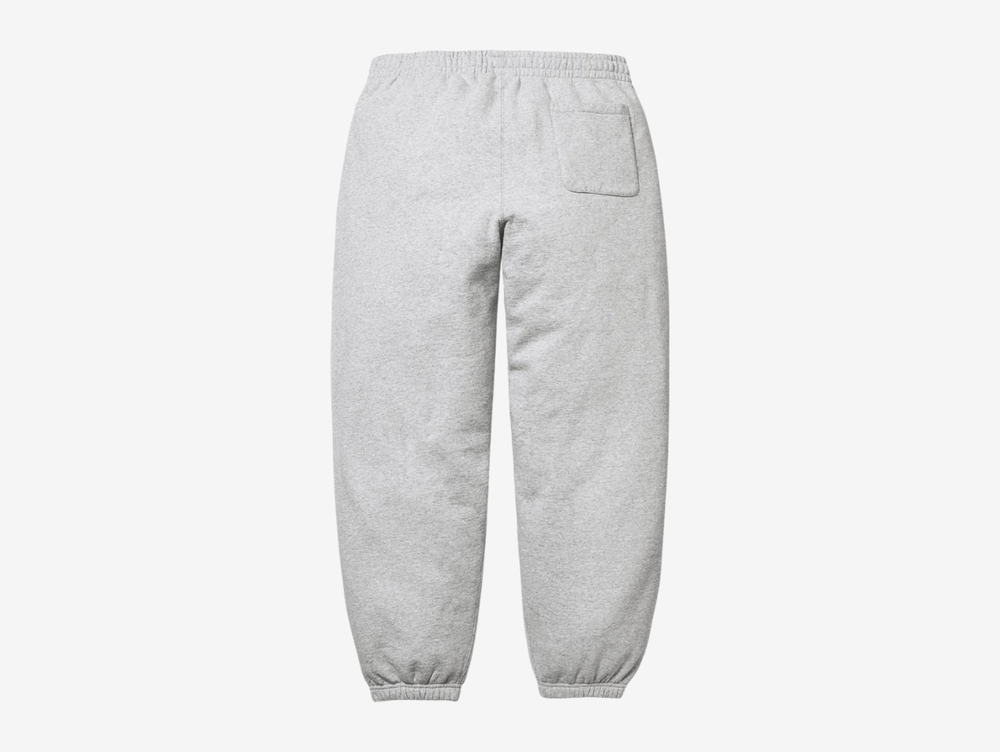 The Supreme Appliqué Logo Sweatpants in Grey bring a clean, versatile look with the same soft, heavyweight fleece for steady comfort. The appliqué Supreme logo along the leg adds texture and a clear point of focus, while the elastic waistband and drawcord secure the fit. The relaxed silhouette keeps them easy to wear, and the neutral grey colorway makes styling simple. These sweatpants fit well for anyone who wants dependable comfort with a sharp Supreme detail.