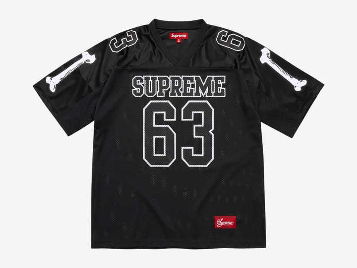 The Supreme Bones Football Jersey Black puts a bold spin on classic athletic wear, merging sport structure with graphic street energy. Made from breathable mesh, it features skeletal-inspired graphics that pop against the clean white base. Striped sleeves and tackle-twill style branding nod to vintage gridiron uniforms, while the relaxed, boxy fit allows easy layering and all-day comfort. A statement piece rooted in sport with unmistakable Supreme attitude.
