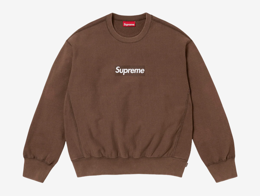 The Supreme Cracked Box Logo Crewneck in Brown offers a warm, vintage look with Supreme’s signature touch. Made from a soft, heavyweight cotton blend, it features the cracked Box Logo graphic on the chest that gives the piece a textured, worn-in feel. The comfortable regular fit makes it easy for daily wear, and the earthy brown colorway adds depth and versatility. This crewneck works well for anyone who wants a classic Supreme staple with a bit of extra character.