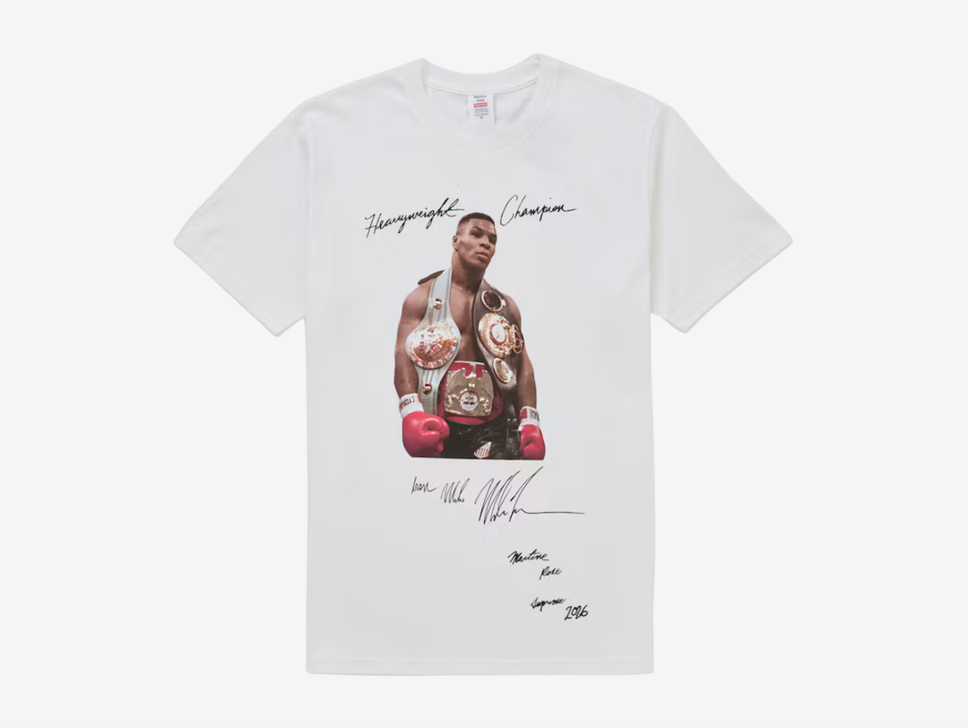 The Supreme Mike Tyson T-Shirt White features the iconic photographic Mike Tyson graphic across the front of a classic white cotton tee. A standout piece from Supreme’s archive, combining the brand’s signature photo-tee style with one of boxing’s most recognisable figures.