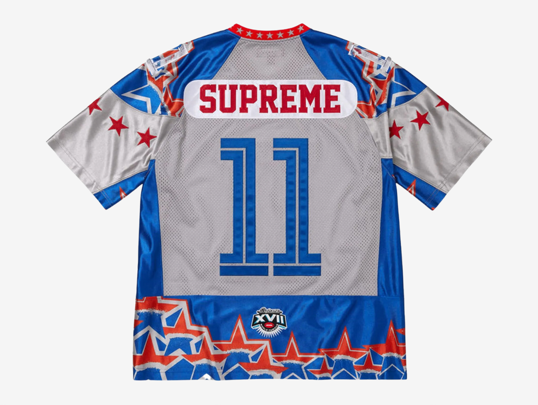 The Supreme Stars Football Jersey in Blue blends a classic athletic design with Supreme’s sharp streetwear attitude. It’s made from breathable mesh that keeps the fit light and comfortable. The star graphics and bold contrast detailing give it a standout look, while the rich blue colorway adds strong visual depth. This jersey is a solid choice for anyone who wants a sporty Supreme piece that feels easy to wear and easy to style.