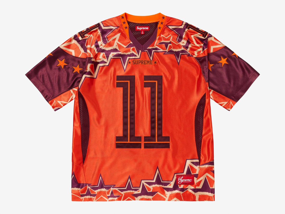 The Supreme Stars Football Jersey in Orange brings a bold athletic look with Supreme’s signature streetwear energy. Built from breathable mesh, it keeps the fit light, airy, and comfortable. The star graphics and contrast detailing give it a strong, standout presence, while the bright orange colorway adds real visual punch. This jersey is a great pick for anyone who wants a sporty Supreme piece that turns heads without trying too hard.