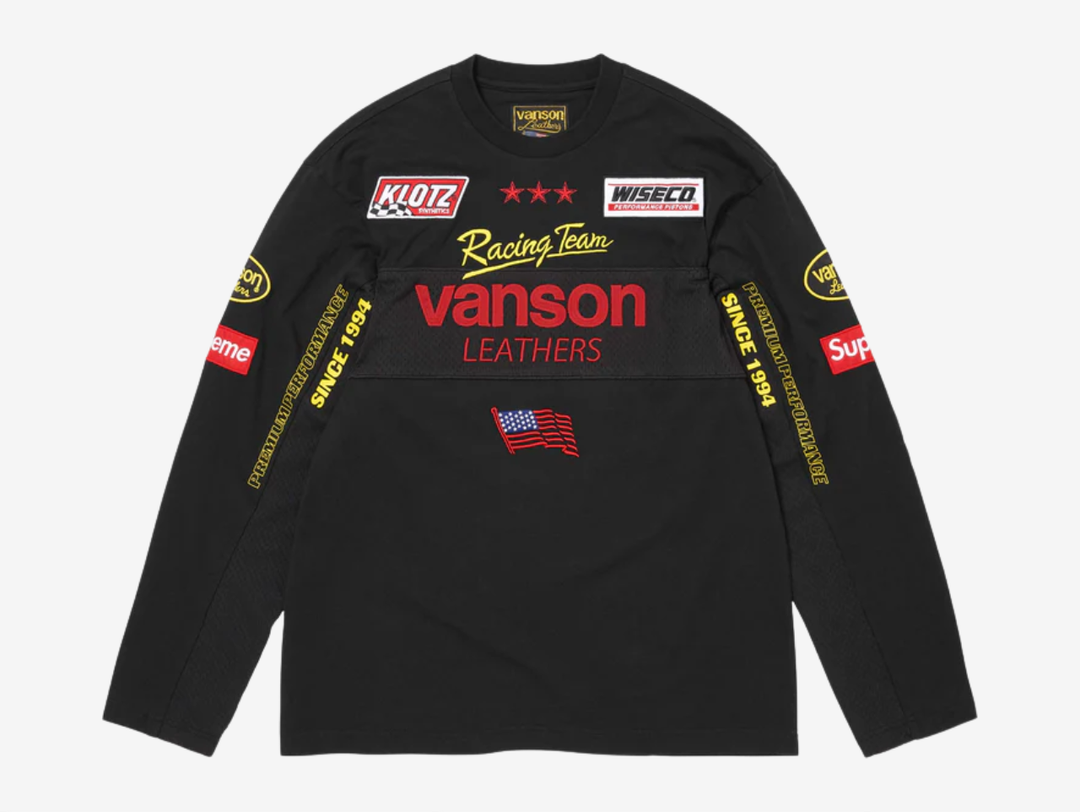 All cotton jersey with cotton mesh panels at chest and sleeves. Embroidered logo patches on chest and sleeves. Embroidered graphics on front and printed graphics on sleeves. Embroidered logo appliqué at back.