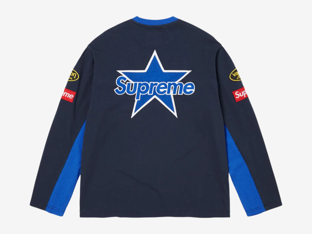 All cotton jersey with cotton mesh panels at chest and sleeves. Embroidered logo patches on chest and sleeves. Embroidered graphics on front and printed graphics on sleeves. Embroidered logo appliqué at back.