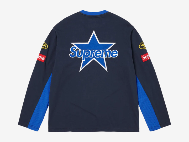 All cotton jersey with cotton mesh panels at chest and sleeves. Embroidered logo patches on chest and sleeves. Embroidered graphics on front and printed graphics on sleeves. Embroidered logo appliqué at back.