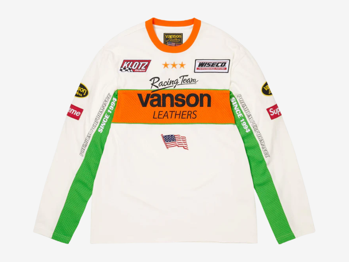 All cotton jersey with cotton mesh panels at chest and sleeves. Embroidered logo patches on chest and sleeves. Embroidered graphics on front and printed graphics on sleeves. Embroidered logo appliqué at back.