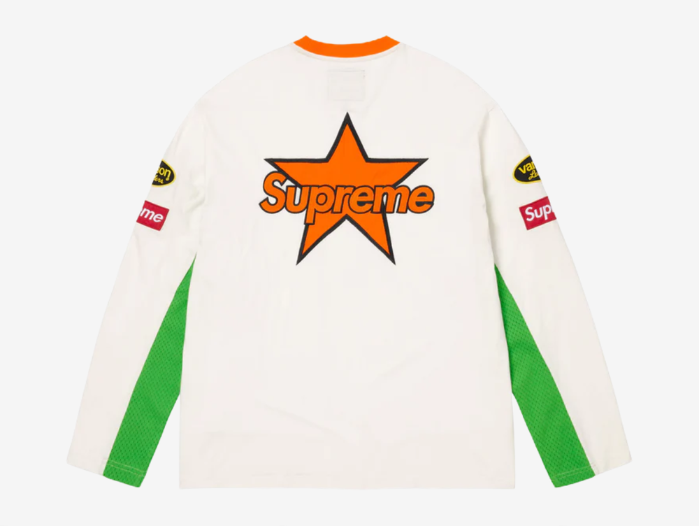 All cotton jersey with cotton mesh panels at chest and sleeves. Embroidered logo patches on chest and sleeves. Embroidered graphics on front and printed graphics on sleeves. Embroidered logo appliqué at back.