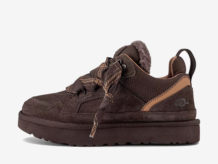 The UGG Lowmel Dusted Cocoa features a warm brown finish across its layered suede and textile upper. The relaxed, chunky silhouette combines casual styling with soft cushioning and signature UGG comfort.