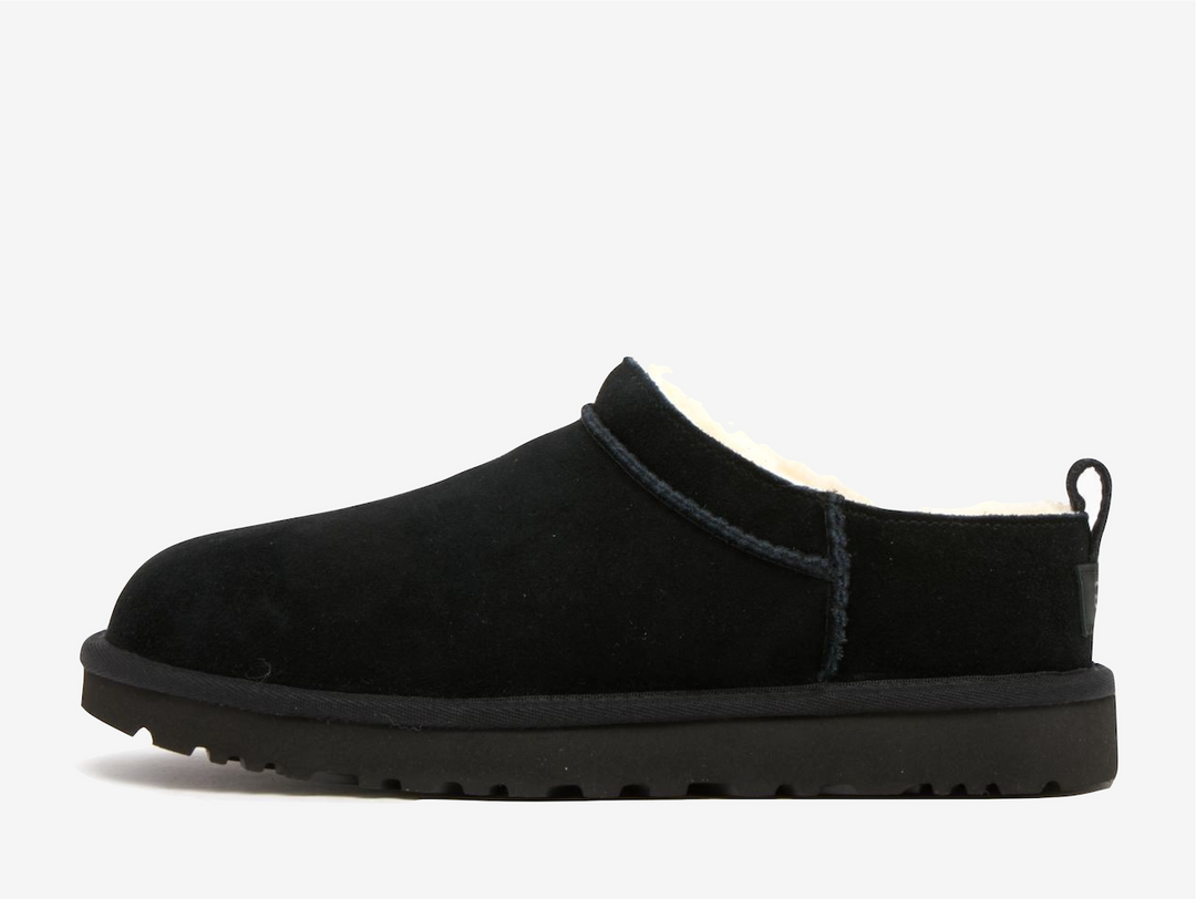 Redefining cosy street style, the UGG Classic Micro Boot Black wraps signature comfort in a sleek, ankle bootie profile. Premium black suede creates a canvas while the plush sheepskin lining delivers that unmistakable UGG embrace against the skin, adapting to your body temperature with natural thermoregulation perfect for winter wear.