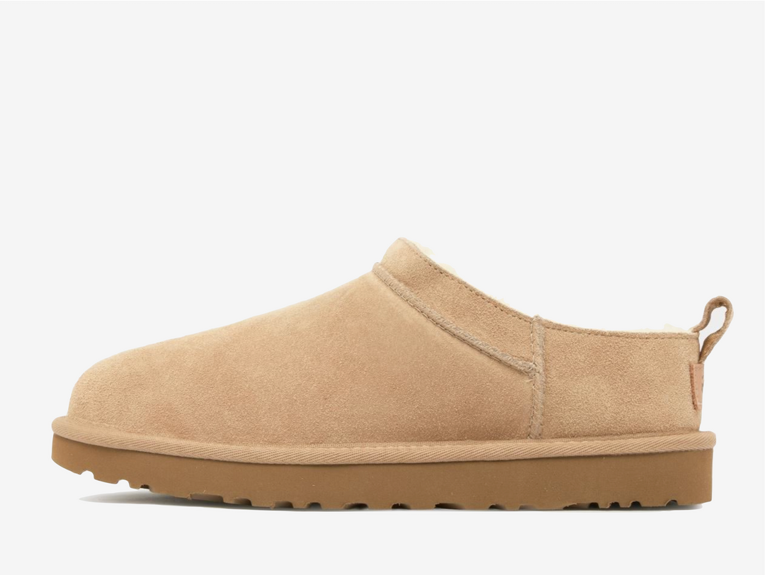 Crafted from premium twinface sheepskin with suede exterior and plush wool interior, the UGG Classic Micro Sand delivers unmatched comfort in a silhouette that transitions effortlessly between seasons. The lightweight, flexible outsole provides reliable traction while maintaining the boot's distinctly laid-back appeal, perfect paired with casual denim or elevated loungewear for that coveted off-duty look.