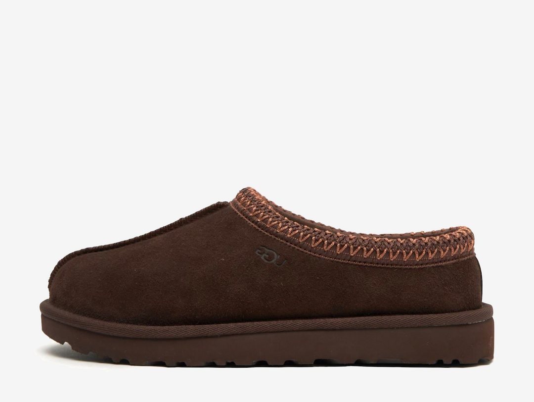 The Tasman II slippers are a sturdy and comfortable slip-on silhouette featuring the same durable outsole as the iconic UGG Classic Boot. Crafted with velvety suede, plush natural wool and embroidered braided detailing. In a stunning 'Burnt Cedar' colourway.