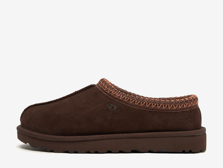 The Tasman II slippers are a sturdy and comfortable slip-on silhouette featuring the same durable outsole as the iconic UGG Classic Boot. Crafted with velvety suede, plush natural wool and embroidered braided detailing. In a stunning 'Burnt Cedar' colourway.
