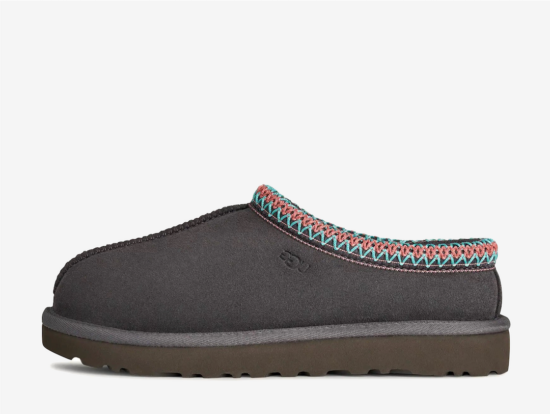 The Tasman II slippers are a sturdy and comfortable slip-on silhouette featuring the same durable outsole as the iconic UGG Classic Boot. Crafted with velvety suede, plush natural wool and embroidered braided detailing. In a classic Grey colourway.