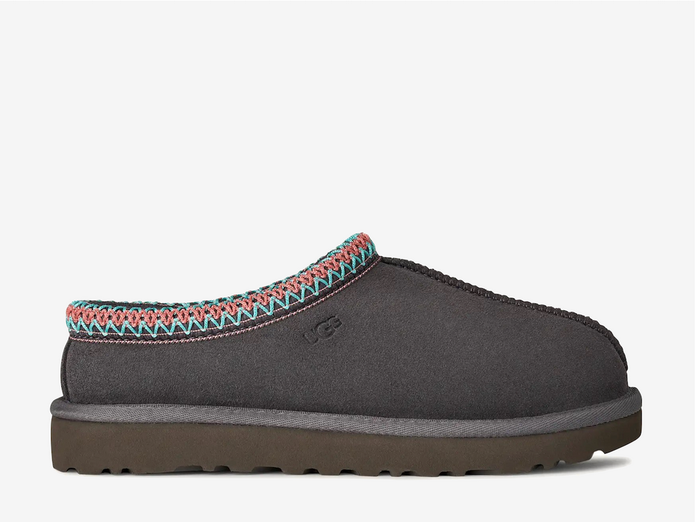 The Tasman II slippers are a sturdy and comfortable slip-on silhouette featuring the same durable outsole as the iconic UGG Classic Boot. Crafted with velvety suede, plush natural wool and embroidered braided detailing. In a classic Grey colourway.