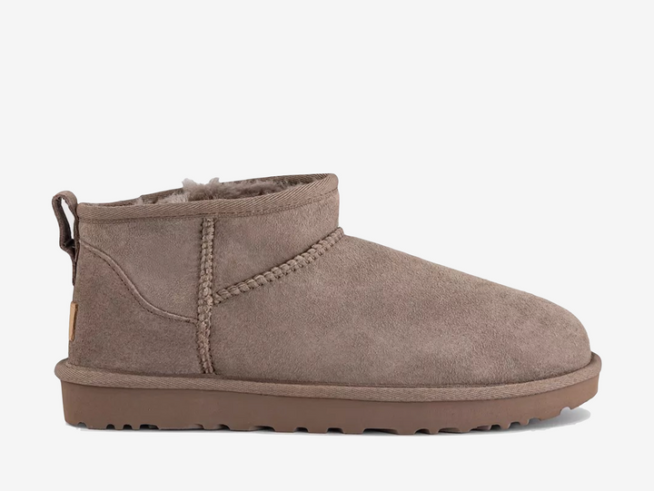The UGG Classic Ultra Mini Caribou takes the iconic UGG silhouette and gives it a lower ankle profile for an easy everyday fit. Crafted from premium suede with a soft sheepskin lining and UGGplush™ sockliner, it delivers the signature warmth and comfort of the Classic range. A water-repellent treatment helps protect the upper, while the lightweight Treadlite by UGG or SugarSole™ outsole provides added cushioning and traction.