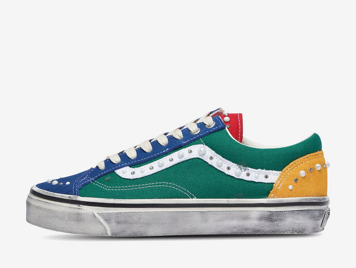 The Vans LX Old Skool 36 Pearlized Yacht Club reworks the classic silhouette with a bold mix of blue, green, red and yellow across its canvas and suede construction. Pearl and stud embellishments are placed throughout the upper and along the signature white side stripe, adding a more decorative finish to the familiar low-top shape. Finished with contrast stitching, off-white laces and a deliberately distressed vulcanised sole, the Yacht Club colourway blends classic Vans styling with a more worn-in look.
