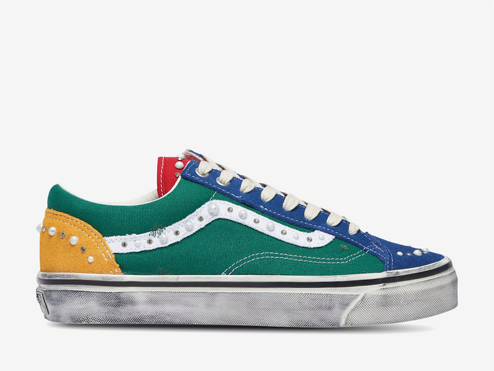 The Vans LX Old Skool 36 Pearlized Yacht Club reworks the classic silhouette with a bold mix of blue, green, red and yellow across its canvas and suede construction. Pearl and stud embellishments are placed throughout the upper and along the signature white side stripe, adding a more decorative finish to the familiar low-top shape. Finished with contrast stitching, off-white laces and a deliberately distressed vulcanised sole, the Yacht Club colourway blends classic Vans styling with a more worn-in look.