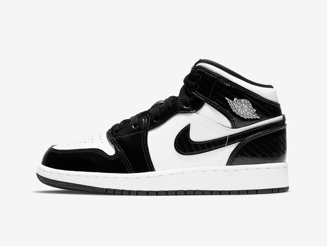 Timeless Air Jordan 1 Mid sneakers in a classic white and black colour scheme.