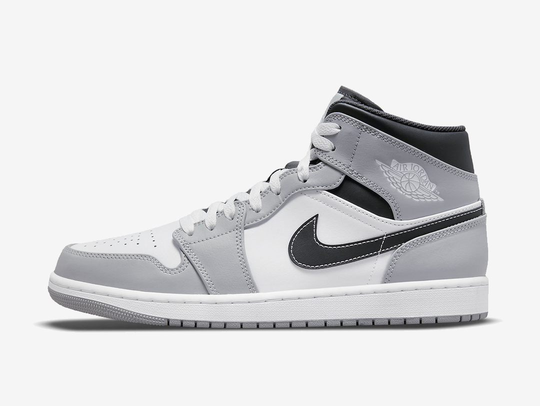 Classic Jordan 1 Mid shoes with a grey, white, and black colourway.