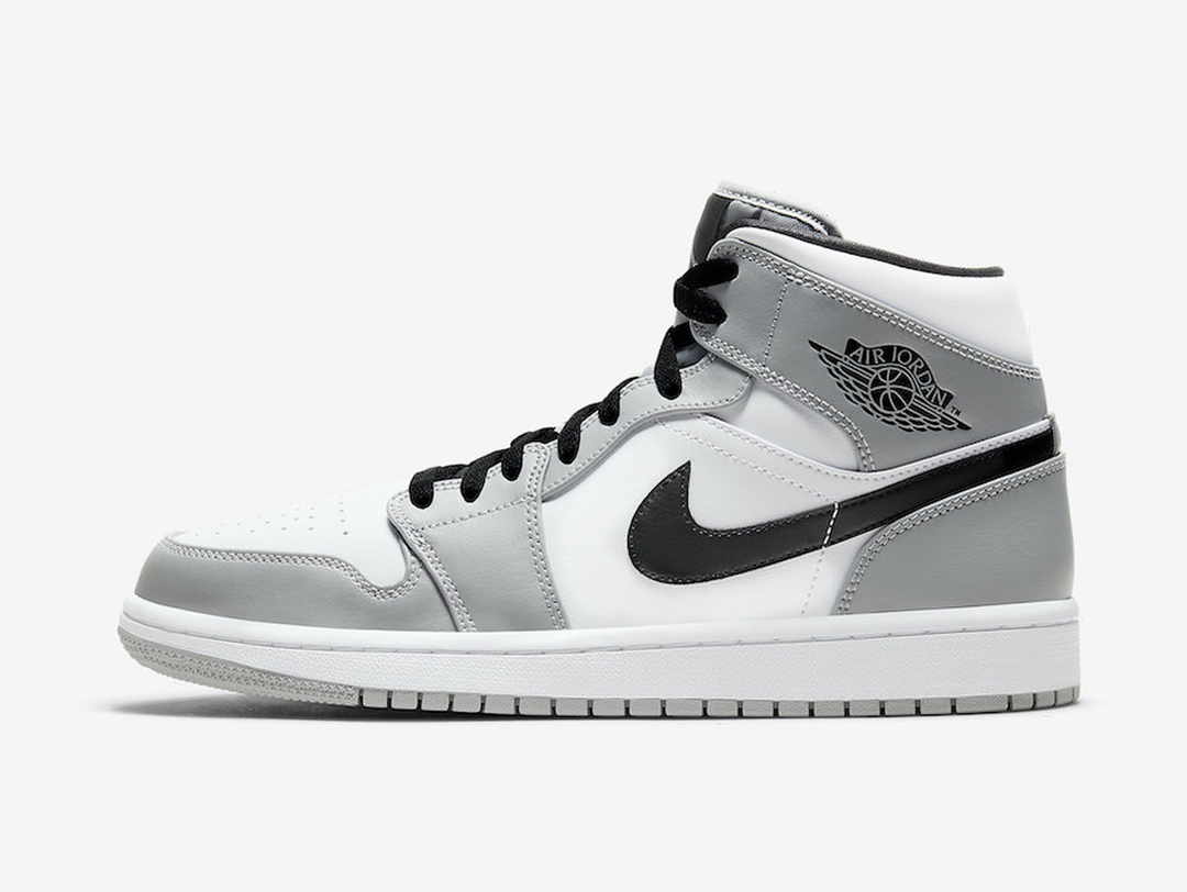 Timeless Air Jordan 1 Mid sneakers in a classic grey and white colour scheme.