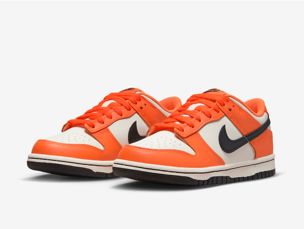 Classic Nike Dunk shoes with a white and orange colourway.