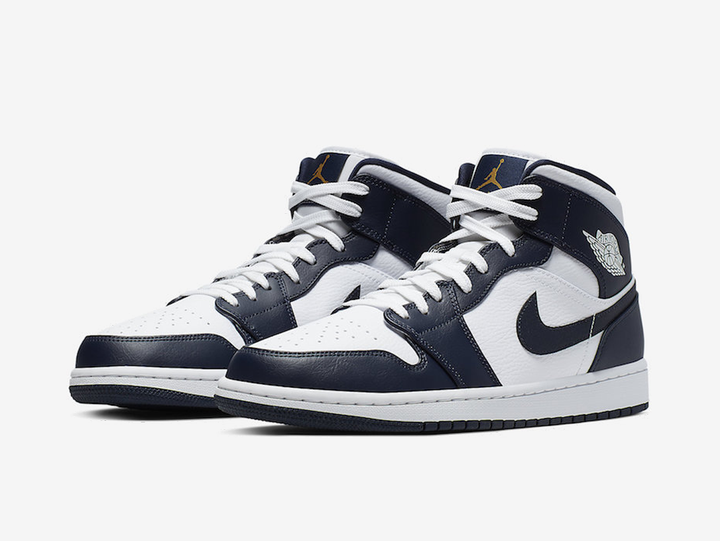 Classic Jordan 1 Mid shoes with a white and navy colourway.