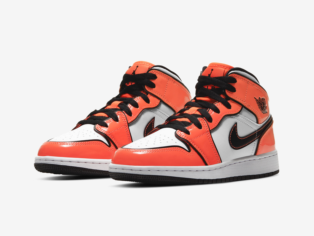 Exclusive Jordan 1 Mid shoes with a unique orange and white colour scheme.