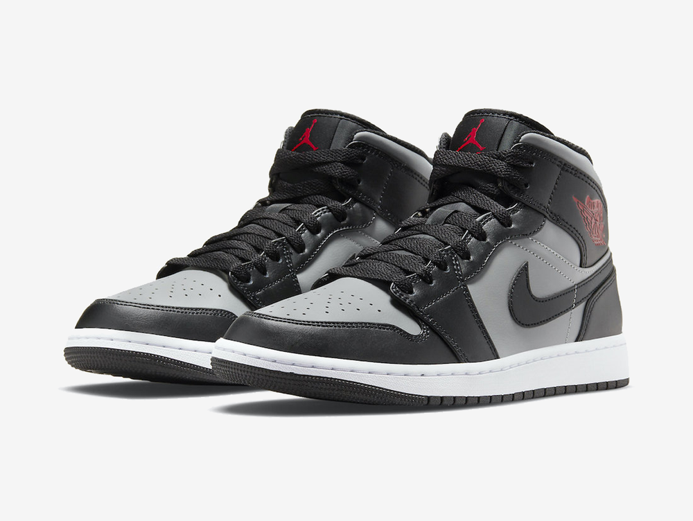 Classic Jordan 1 Mid shoes with a red, grey, and black colourway.