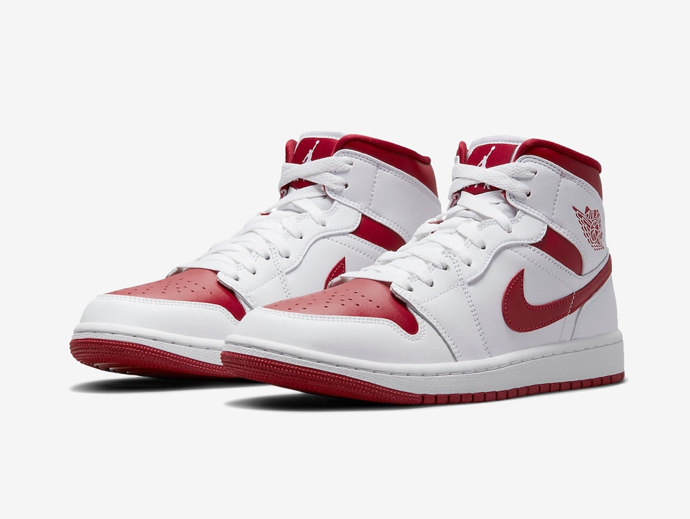Timeless Air Jordan 1 Mid sneakers in a classic white and red colour scheme.