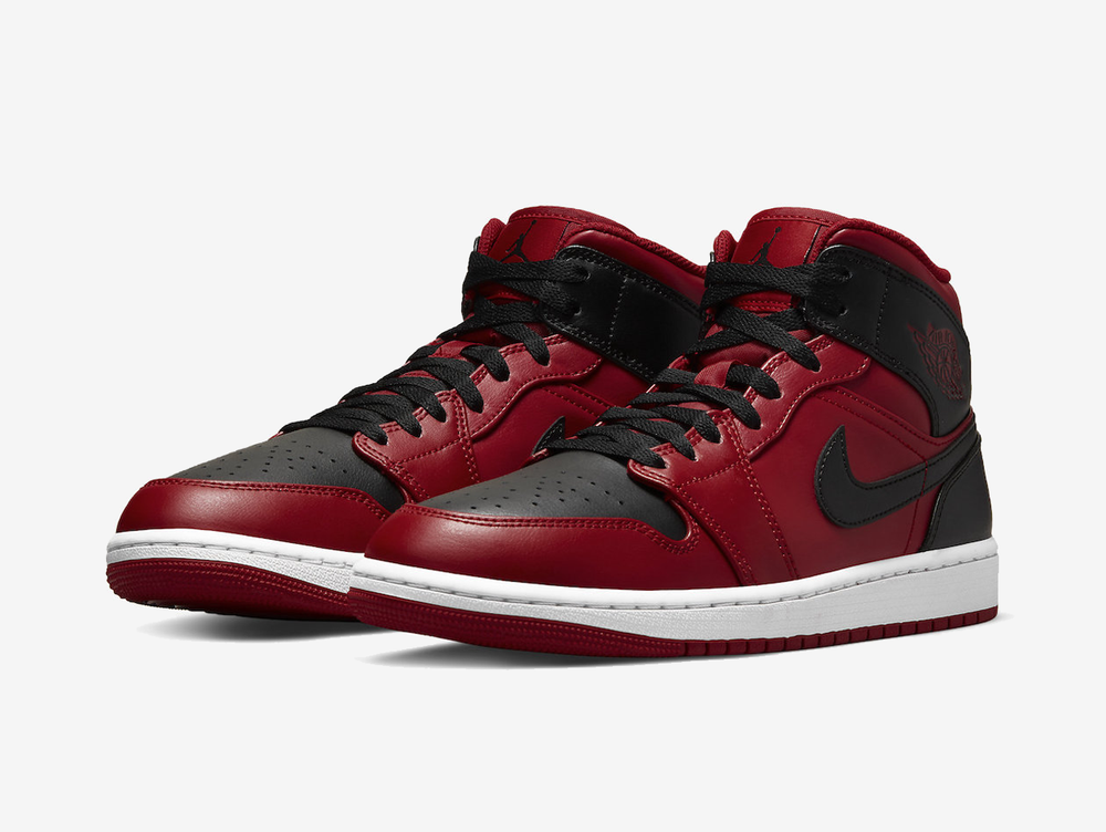 Classic Jordan 1 Mid shoes with a red and black colourway.