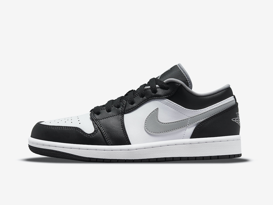 Classic Jordan 1 Low shoes with a grey, white, and black colourway.