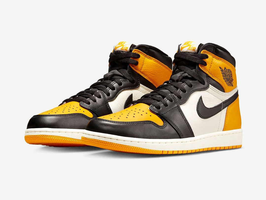 Classic Jordan 1 High shoes with a yellow, white, and black colourway.